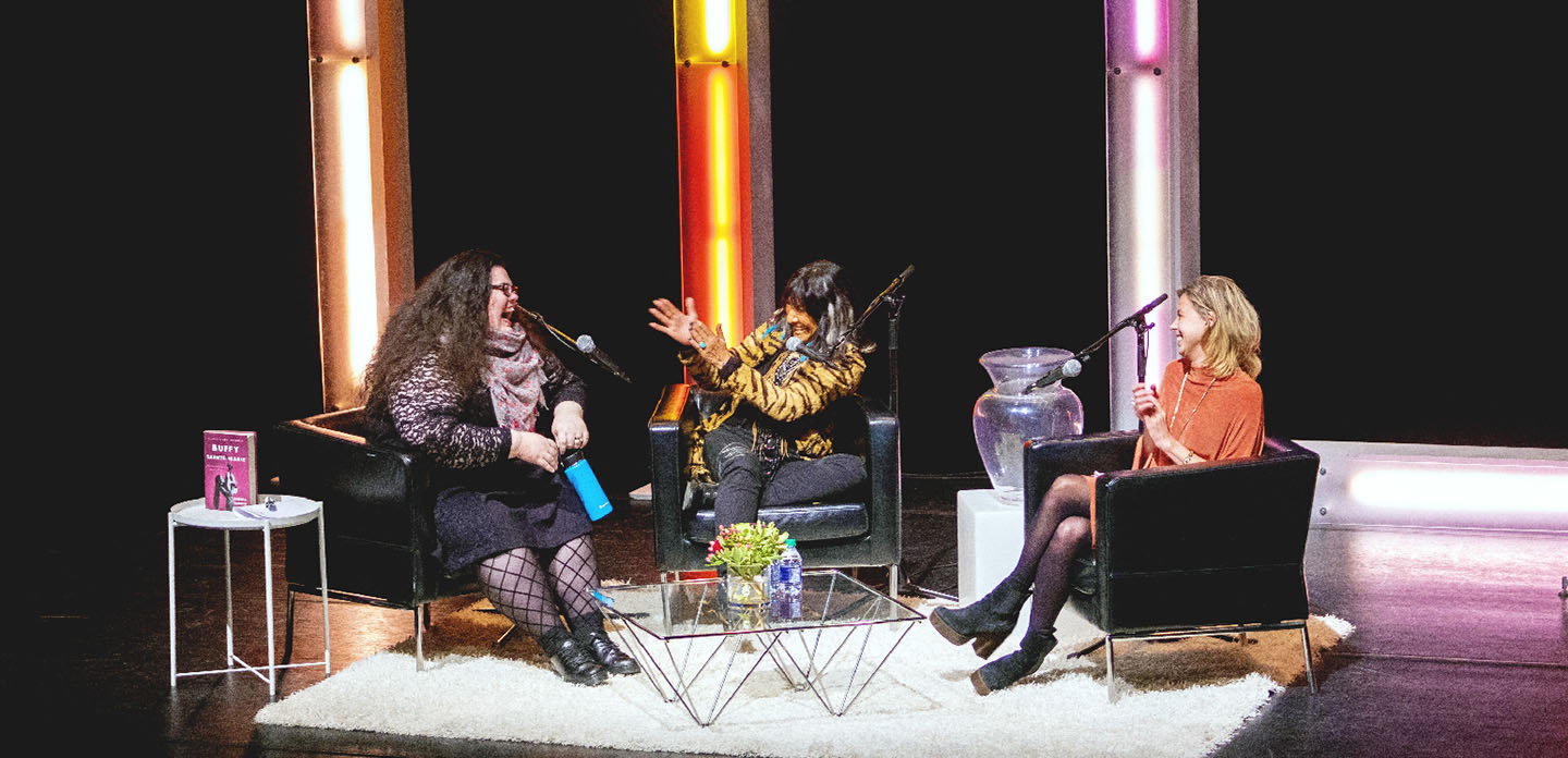 Photo of Buffy St. Marie being interviewed on stage