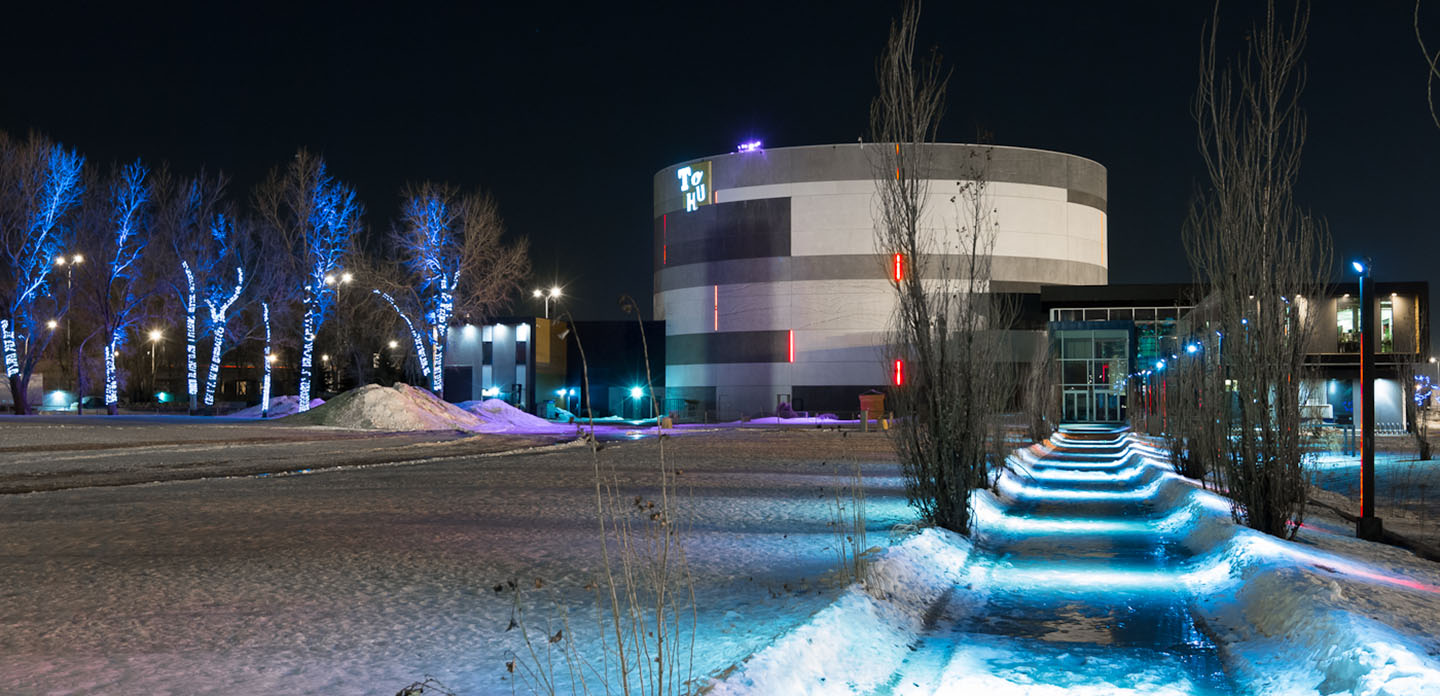 Photo of TOHU outside at night in the winter. 